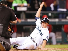 Seattle Mariners third baseman Kyle Seager slides home to score a run against the Los Angeles Angels during the seventh inning at Safeco Field on September 27, 2014. (Joe Nicholson/USA TODAY Sports)