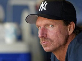 New York Yankees pitcher Randy Johnson sits in his team's dugout on his day off the mound during a game against the Seattle Mariners at Safeco Field in Seattle on September 1, 2005. (Reuters)