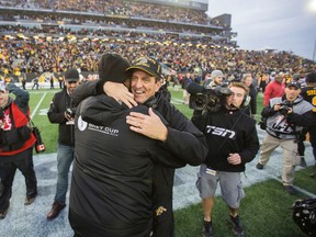 Tiger-Cats head coach Kent Austin gets a hug after Hamilton beat the Montreal Alouettes in the Eastern final at Tim Hortons Field on Sunday. (Ernest Doroszuk/Toronto Sun)