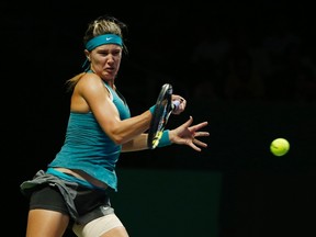 Eugenie Bouchard of Canada hits a return to Simona Halep of Romania during their WTA Finals singles tennis match in Singapore October 20, 2014. (REUTERS/Edgar Su)