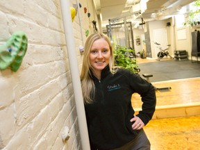 Bailey Hart, owner of Studio b., designed a climbing wall in her Dundas St. fitness studio. The gym goes beyond traditional fitness offerings, including aerial yoga. (CRAIG GLOVER/The London Free Press)