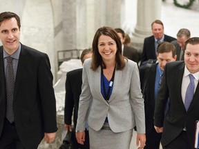 Wildrose Party leader Danielle Smith, (centre) surrounded by MLAs including Rob Anderson (left) and Rod Fox (right), heads to Question Period in the Alberta Legislature in Edmonton on Monday. (IAN KUCERAK/Edmonton Sun)