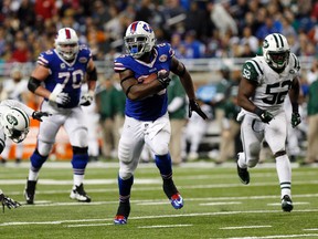 Buffalo Bills running back Anthony Dixon (26) runs for a touchdown as New York Jets inside linebacker David Harris (52) pursues during the second half at Ford Field on Nov. 24, 2014. Bills beat the Jets 38-3. (Kevin Hoffman-USA TODAY Sports)