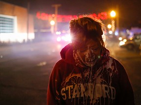 A protester stands in the street after being treated for tear gas exposure after a grand jury returned no indictment in the shooting of Michael Brown in Ferguson, Mo., on November 24, 2014. (REUTERS/Adrees Latif)