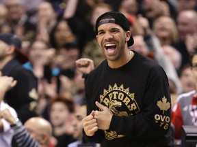 Drake celebrates a Toronto Raptors win over the Brooklyn Nets on 'Drake Night' at the Air Canada Centre in Toronto Jan. 11, 2014. (Craig Robertson/Toronto Sun)