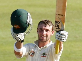 Australia's Phil Hughes celebrates his century during the third day of the second cricket test match against South Africa in Durban in this March 8, 2009 file photo. Former Australia batsman Hughes was rushed to a Sydney hospital on November 25, 2014 after being struck by a short delivery when batting for South Australia in a Sheffield Shield match. REUTERS/Mike Hutchings/Files