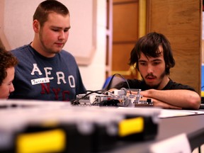 Joey Voth, Jarred Giesbrecht, and David Stanley (From left to right) with their robot as they compete in the Oxford Invitational Youth Robotics Challenge on Tuesday at Goff Hall in Woodstock. (BRUCE CHESSELL/Sentinel-Review)