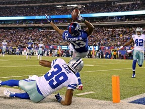 New York Giants wide receiver Odell Beckham catches a touchdown pass over Dallas Cowboys cornerback Brandon Carr during the second quarter of an NFL game at MetLife Stadium in East Rutherford, N.J., on Sunday night. (Adam Hunger/USA TODAY Sports)