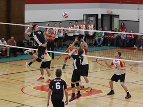 Strathcona Lords middle Mason Fairless goes up in a bid to block an attack by the Jasper Place Rebels, part of a season-long volleyball rivalry that ended when the second-ranked Rebs edged Scona in the provincial final for large high schools. In five matches this season, the Rebels earned a narrow 3-2 edge but Scona entered the finals as the top seed. One of the standouts for NAIT in the five-set final was Nathan Hayashi (10), here being aided by grade-11 setter Josh Kennedy.