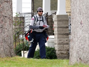 Ryan Norrington, a Canada Post letter carrier for 14 years, delivers mail door-to-door in London. (Free Press file photo)