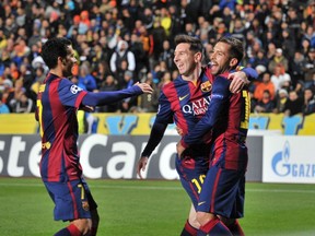 Barcelona's Lionel Messi (middle) celebrates with teammates after scoring during their Champions League match against APOEL Nicosia at GSP Stadium in Nicosia November 25,  2014. (REUTERS/Andreas Manolis)