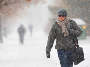 Douglas Scandrett walks through a snow flurry as he heads to classes in London, Ont., on November 19, 2014. (Mike Hensen/QMI Agency)