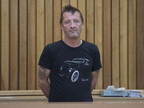 Former AC/DC drummer Phil Rudd stands in the dock as faces charges at the High Court in Tauranga, New Zealand on November 26, 2014. (AFP photo)