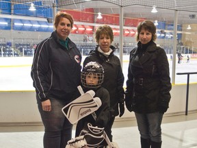 Cambrian Insurance's Joelle Proulx and Nancy Thomas pose with Lorrie O'Connor and 1st year senior Tyke Logan Crawford (5) on Thursday Nov. 20th at the Tim Horton Event's Centre after Proulx presented the new goalie equipment. Crawford is wearing the new goalie equipment which had been given to the CMHA as part of the OMHA and IBAO Goaltender Assist Program.