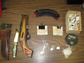 Money, drugs and weapons seized by RCMP after stopping a car in Spruce Grove, Tuesday Nov. 25, 2014. (RCMP PHOTO)