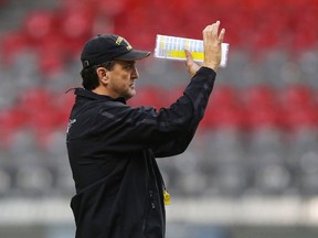 Hamilton Tiger Cats head coach Kent Austin signals instructions to his team during their team practice at the CFL's 102nd Grey Cup week in Vancouver, British Columbia, November 26, 2014. (REUTERS/Todd Korol)