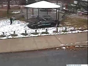 A police officer (left) is seen pointing his weapon during the shooting of a 12-year-old boy in Cleveland, in this still image from a video released by the Cleveland Police Department, Nov. 26, 2014. (Cleveland PD/Reuters/Handout)