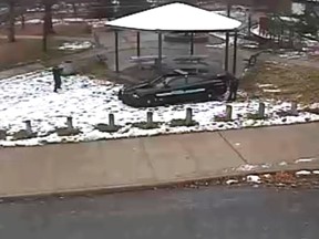 A police officer (left) is seen pointing his weapon during the shooting of a 12-year-old boy in Cleveland, in this still image from a video released by the Cleveland Police Department, Nov. 26, 2014. (Cleveland PD/Reuters/Handout)