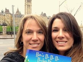 Pam Helmer (left) and Kary Carkner with their book Hero's Ho Ho Ho Hockey Dream. SUBMITTED