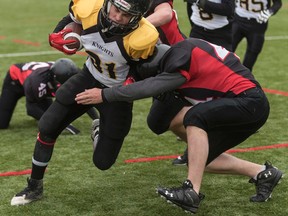 La Salle Black Knights fullback Dalin Price tries to get past a Fenelon Falls tackler during the National Capital Bowl junior AA football final at Mary Ann Sills Park in Belleville on Wednesday. (JAMES PADDLE-GRANT/FOR THE WHIG-STANDARD)