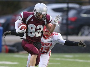 Andrew Braby of the Frontenac Falcons tries to break away from a Richview Collegiate player during OFSAA football action at Ron Joyce Stadium in Hamilton on Wednesday. The Falcons won 24-20. (Dave Thomas/QMI Agency)