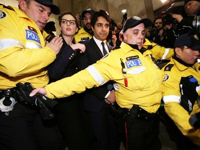 Jian Ghomeshi leaves College Park court after being freed on bail Wednesday, November 26, 2014. (Craig Robertson/Toronto Sun)