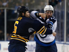 Jets winger Anthony Peluso mixes it up with Sabres defenceman Mike Weber in Buffalo Wednesday. (KEVIN HOFFMAN/USA TODAY Sports)