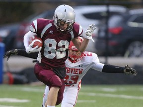 Andrew Braby of the Frontenac Falcons pulls away from attempted tackle of a Richview Saints defender during Wednesday's OFSAA bowls game at Ron Joyce Stadium in Hamilton. The Falcons held on to win 24-20. (DAVE THOMAS, Toronto Sun)