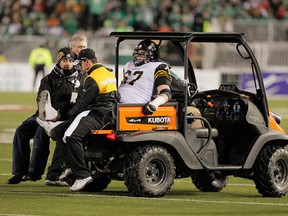 Hamilton Tiger-Cats Peter Dyakowski gets taken off the field during the 101st CFL Grey Cup game between the Roughriders and the Hamilton Tiger-Cats in Regina, Sask., on Sunday, Nov. 24, 2013. (Lyle Aspinall/QMI Agency)