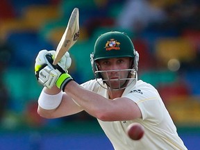 Australia's Phillip Hughes watches his shot during the fourth day of their third and final test cricket match against Sri Lanka in Colombo in this September 19, 2011 file photo. (REUTERS/Dinuka Liyanawatte/Files)
