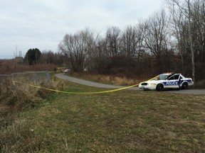 Ottawa Police cordon off an area along a bike path behind the South Keys shopping mall after the discovery of a man's body Thursday morning. (TONY CALDWELL Ottawa Sun)