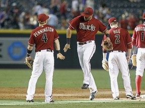 Members of the Arizona Diamondbacks celebrate a 6-2 victory against the Colorado Rockies during a MLB game at Chase Field on August 31, 2014. (Ralph Freso/Getty Images/AFP)