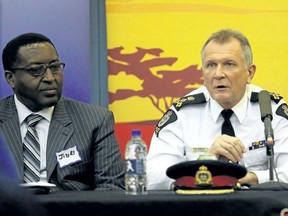 Edmonton Police Service Chief Rod Knecht, right, answers questions from members of Edmonton's African community at the African Community Liaison Committe (ACLC) town hall meeting at the Africa Centre, 13160 127 St., on Wednesday.