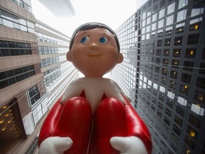 The Elf on the Shelf balloon floats down Sixth Avenue during the 88th Annual Macy's Thanksgiving Day Parade in New York November 27, 2014. REUTERS/Andrew Kelly