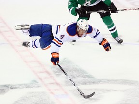 Taylor Hall #4 of the Edmonton Oilers is tripped by Ryan Garbutt #16 of the Dallas Stars in the third period at American Airlines Center on November 25, 2014 in Dallas, Texas. Garbutt was suspended two games for the hit. (Ronald Martinez/Getty Images/AFP)