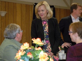 Ontario PC Party leadership candidate Christine Elliott, centre, speaks with two members of an audience who heard her speak Thursday at the Royal Canadian Legion Colonel Talbot Branch 81 in Aylmer. Elgin-Middlesex-London PC MPP Jeff Yurek, standing in back, is supporting Elliott's leadership bid.

Ben Forrest/Times-Journal