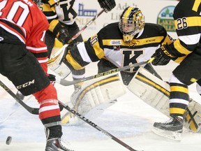 Kingston goaltender Lucas Peressini watches the bouncing puck during a scramble in front of the Frontenacs net during the first period of a game against the Owen Sound Attack in Kingston on Nov. 21. (Elliot Ferguson/The Whig-Standard)