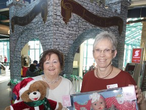 Joyce Gittins (left) and Linda Grayston at The Toy Tower gift donation structure at The Forks.