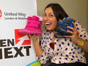 With two pair in hand, Katy Boychuk of GenNextUW.ca now only needs another 458 pairs of boots to be donated to the Give Cold Feet The Boot campaign in London. The Gen Next drive will crowd-source boot drives in the workplace, and donors can buy boots or gift cards for stores like Walmart and Target so boots can be purchased if certain sizes aren?t donated. (Mike Hensen/The London Free Press)