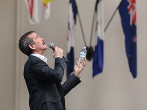 Col. Chris Hadfield uses a water bottle to describe a rocket liftoff during Thursday's talk at KCVI. (Elliot Ferguson/The Whig-Standard)