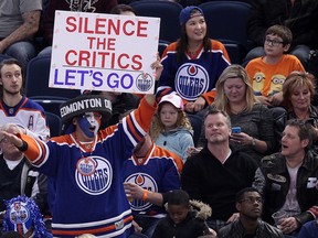 Oilers fan Blair Madoo Gladue holds up a sign during third period NHL action between the Oilers and Devils in Edmonton on Nov. 20, 2014. (David Bloom/QMI Agency)