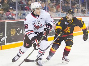 Belleville Bulls defenceman Alex Yuill covers Niagara Ice Dogs puckcarrier Ryan Mantha during OHL action Thursday night in St. Catharines. (Julie Jocsak/St. Catharines Standard)