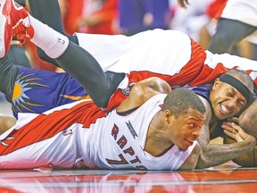 Raptors’ Kyle Lowry (bottom) and Amir Johhson fight for the ball with Phoenix Suns’ Isaiah Thomas during their game last week. (ERNEST DOROSZUK/Toronto Sun)