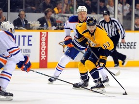 Oilerws defenceman Nikita Nikitin chases Predators forward Mike Ribeiro during first-period action Thursday in Nashville. (USA TODAY SPORTS)