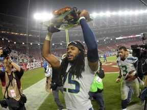 Seattle Seahawks cornerback Richard Sherman (25) hoists a turkey in celebration after the game against the San Franciscco 49ers at Levi's Stadium.The Seahawks defeated the 49ers 19-3 in the Thanksgiving Day game on Nov 27, 2014 in Santa Clara, CA, USA. (Kirby Lee-USA TODAY Sports)