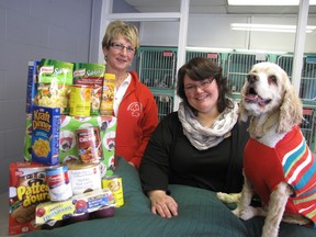 Brenda LeClair, Outreach For Hunger executive director, Robyn Brady, community relations co-ordinator for the Kent branch of the OSPCA, and Bernadette, an American cocker spaniel, were on hand to launch a new holiday food drive. Between Dec. 1 and Dec. 21, any cat or dog adopted from the Kent shelter will be eligible for a discounted rate with a donation to Outreach for Hunger.