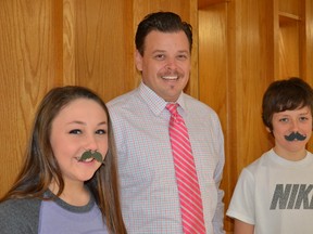 Seaforth Public School Grade 7/8 students Corrinn Lostell and Cole Zwep don some mustache support with vice principal, Jeremy Brock.