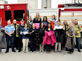 Members of the Catholic Central high school Crusaders in Action club and the London Fire Department stand near a fire truck at the school Nov. 26, 2014. CHRIS MONTANINI\LONDONER\QMI AGENCY