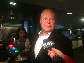 Doug Ford speaks to reporters at City Hall on Friday. (DON PEAT/Toronto Sun)