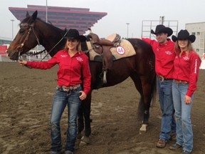 Carly Hurrel of London, left, and Krista McNea of West Lorne, right, stand with coach Chris Blane and a Canadian horse that helped them win the recent Shanghai Barrel Racing World Cup. Hurrel and McNea represented Canada in the competition, defeating defending champion Brazil in the final.